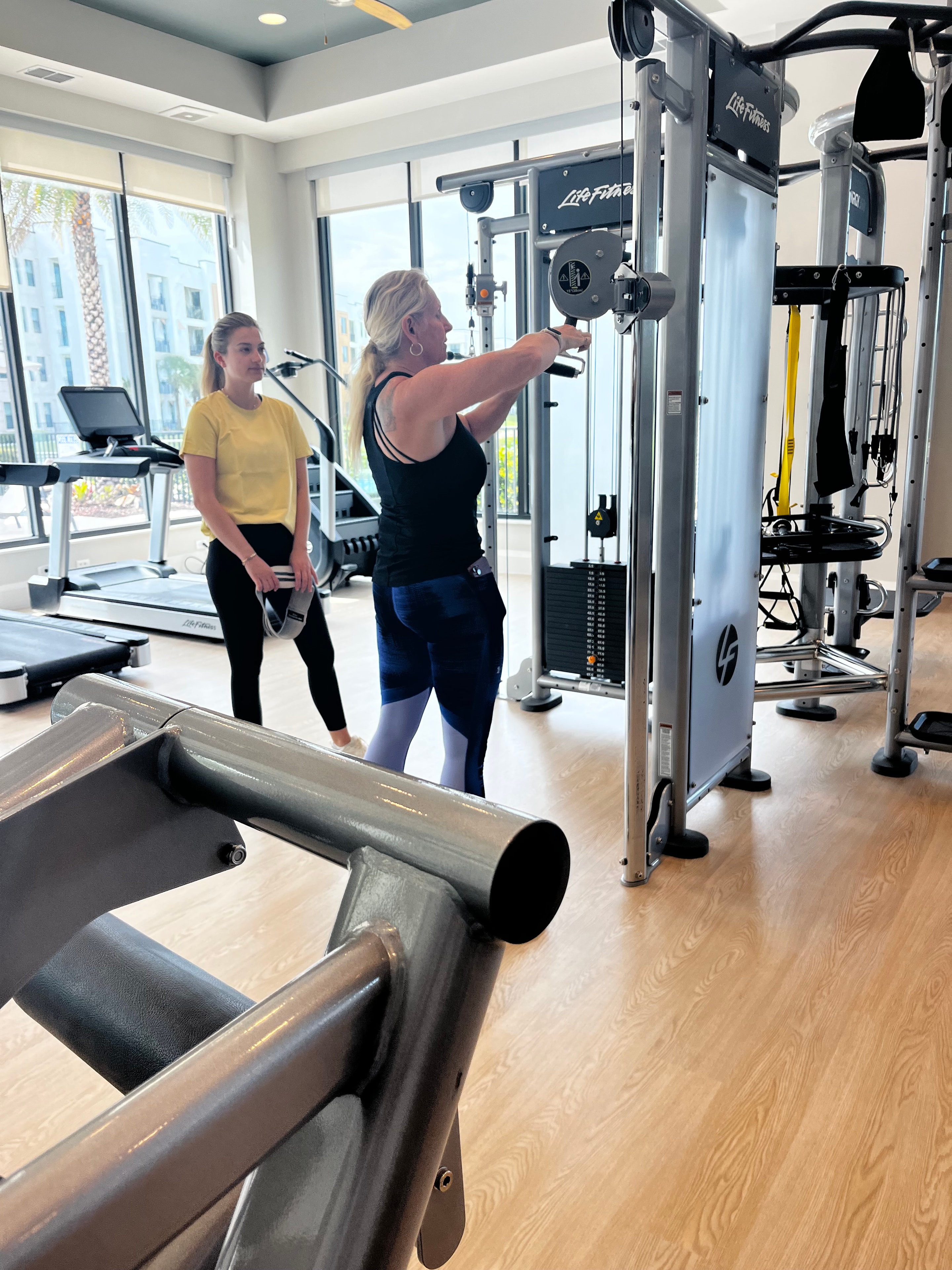 Personal trainer coaching a senior fitness client